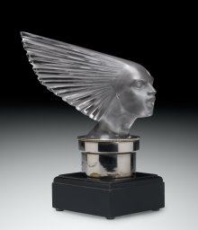Automobile Mascot, Victoire (Victory), designed 1928. Mold-pressed glass, acid-etched; metal radiator cap, wood base. H. 23 cm, W. 24.6 cm, D. 10.1 cm. (2011.3.345, gift of Elaine and Stanford Steppa)