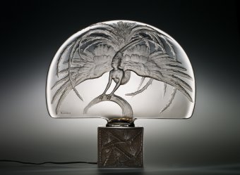 Illuminated Surtout de table, Oiseau de Feu (Firebird) Rene Lalique (French, 1860-1945) France, Combs-la-Ville or Wingen-sur-Moder, R. Lalique et Cie., about 1922 Mold-pressed, acid-etched intaglio design H: 42.2 cm Collection of The Corning Museum of Glass, Corning, New York, Gift of Elaine and Stanford Steppa (2011.3.189) 