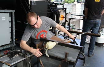 Gaffer Eric Meek works with designer Sigga Heimis in a GlassLab session in Corning, May 2012