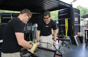 Glassmakers Tom Ryder and Ian Schmidt works with Steven and William Ladd at GlassLab in Corning, August 2012